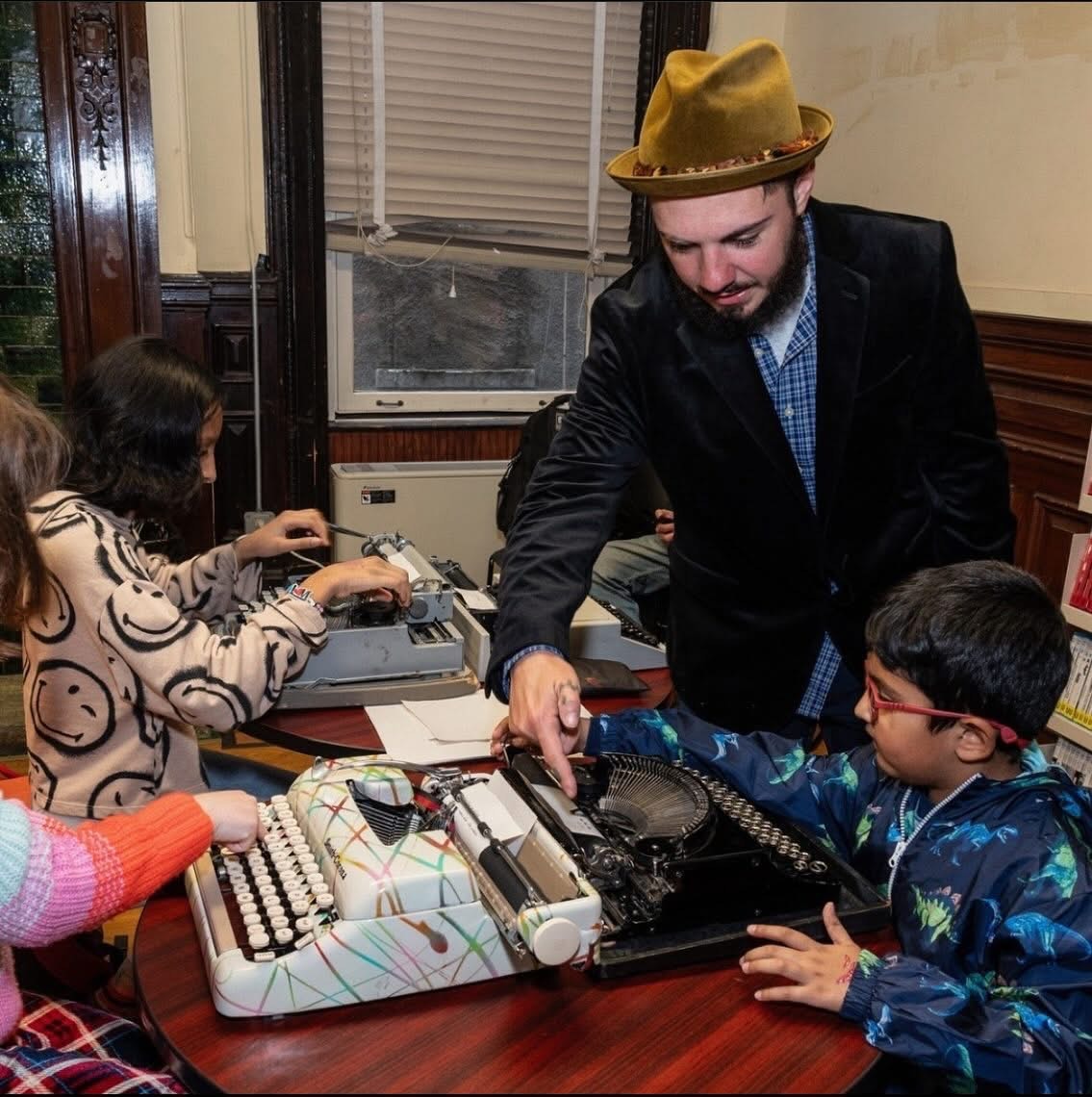 Children engaging with typewriter poetry